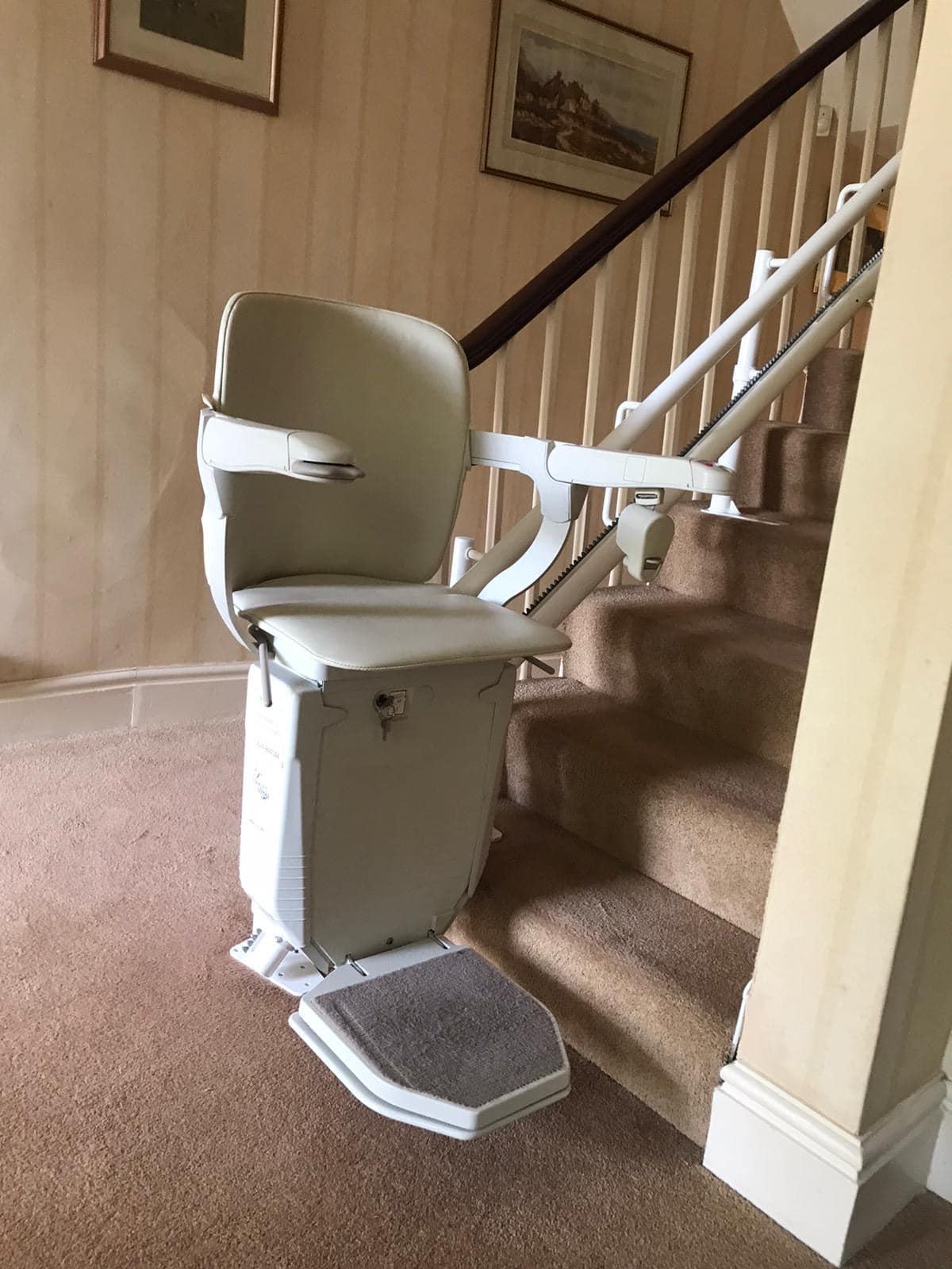 Prestige Stairlift on twin rail in its ready position at the bottom of stairs