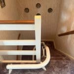Stairlift rail at the top of a curved staircase