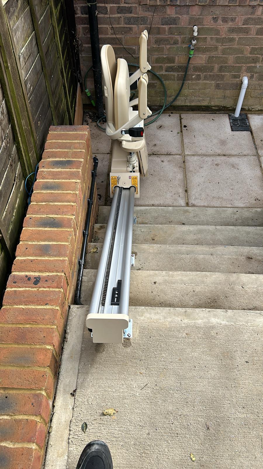 External stairlift at the bottom of steps showing track
