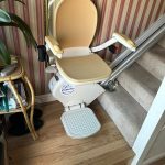 Stairlift in its ready position parked at bottom of stairs