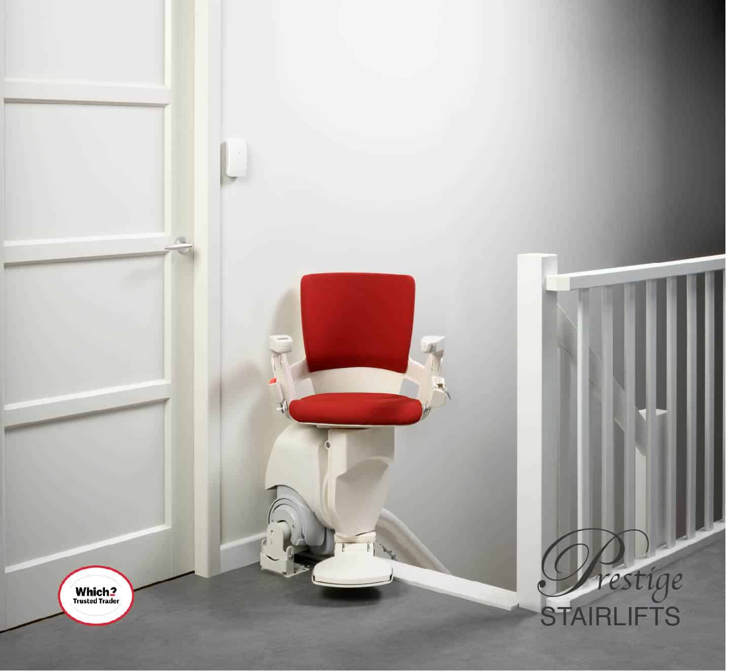 Otolift stairlift with red upholstered seat at the top of the stairs in its swivel position