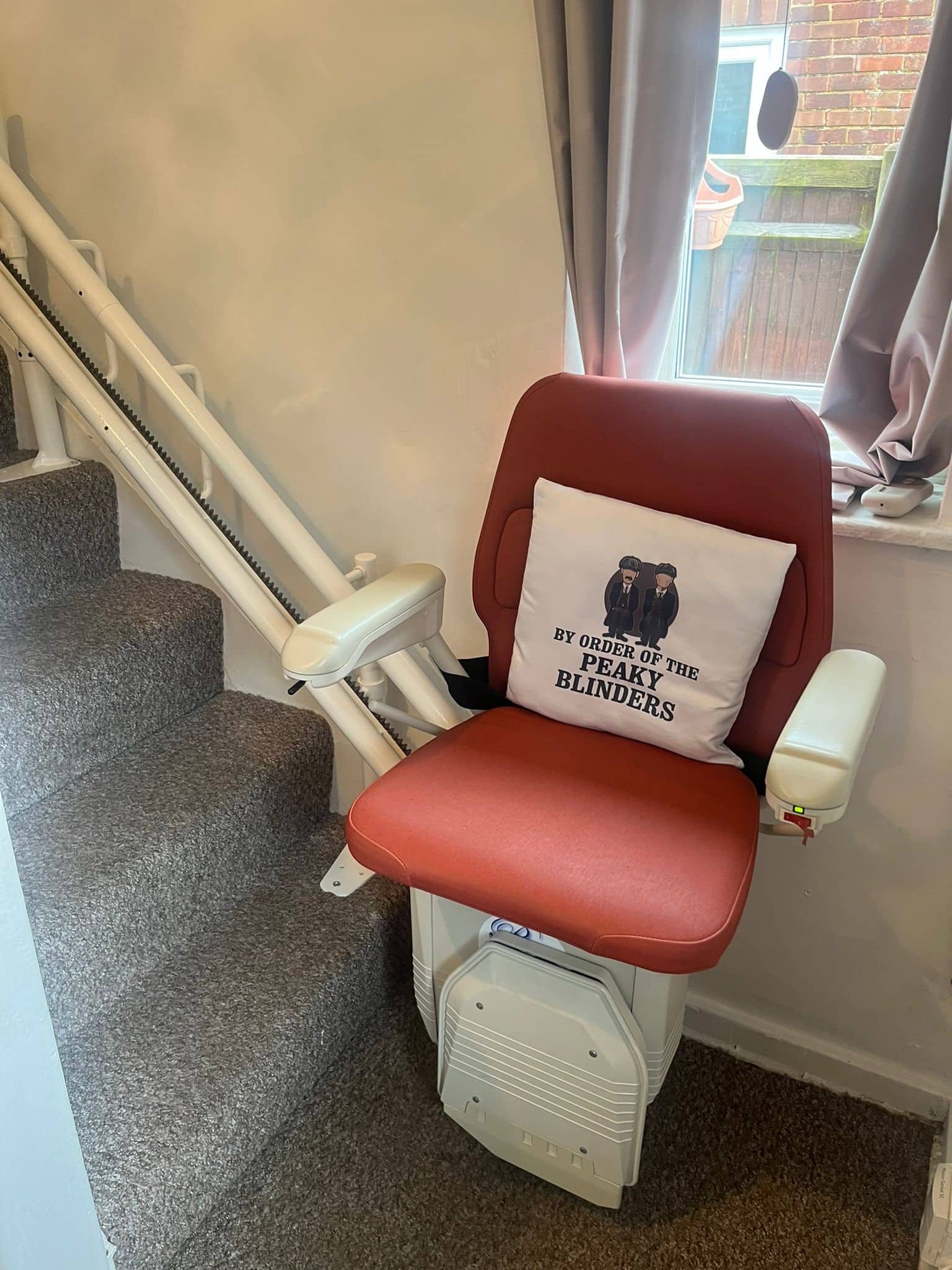 Prestige curved stairlift with a twin rail at the bottom of the stairs