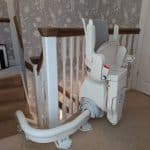 Otolift stairlift demonstrated from the side view in its folded position at the top of the stairs