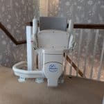 Otolift stairlift in its folded position at the top of the stairs