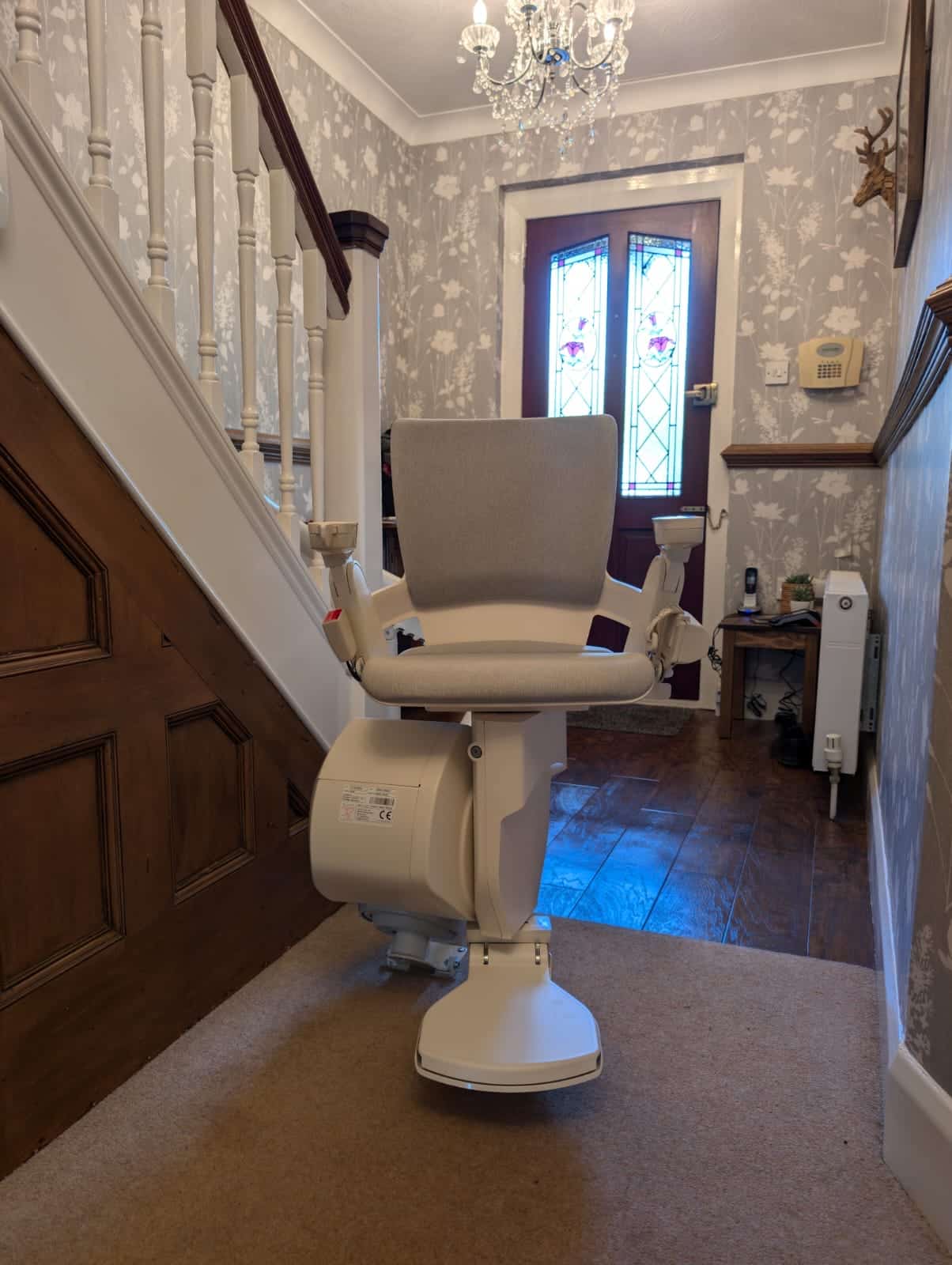 Otolift stairlift in ready position at the bottom of the stairs