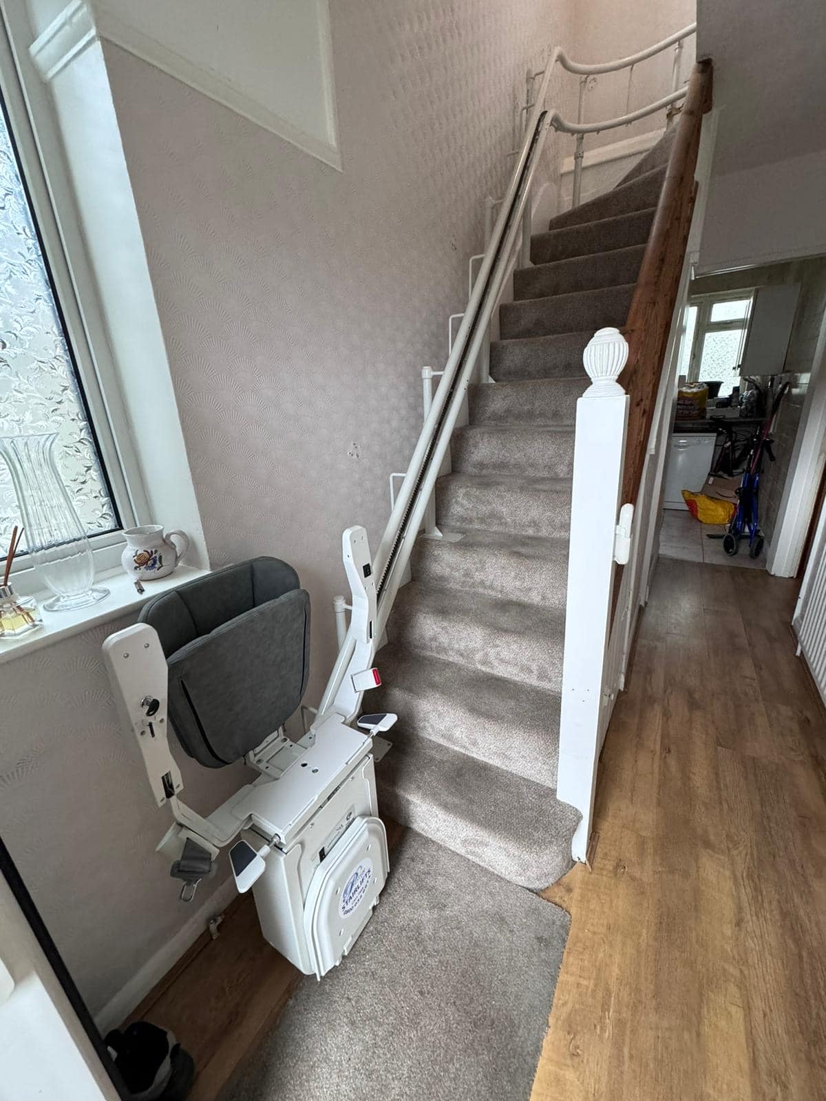 Platinum stairlift in folded position at the bottom of the stairs showing clearance on stairs