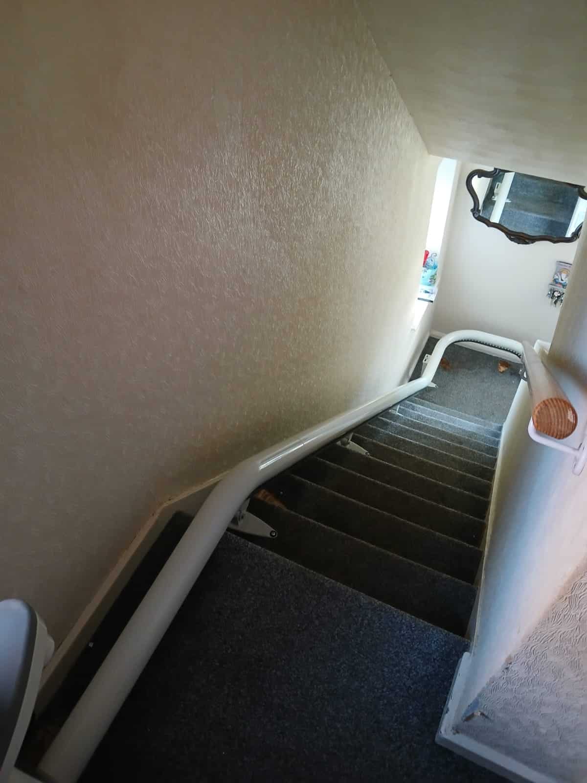 Single curved stairlift rail illustrated from the top of the staircase to the first curve