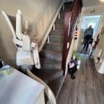 Stairlift shown in one of its parking positions up the curved staircase