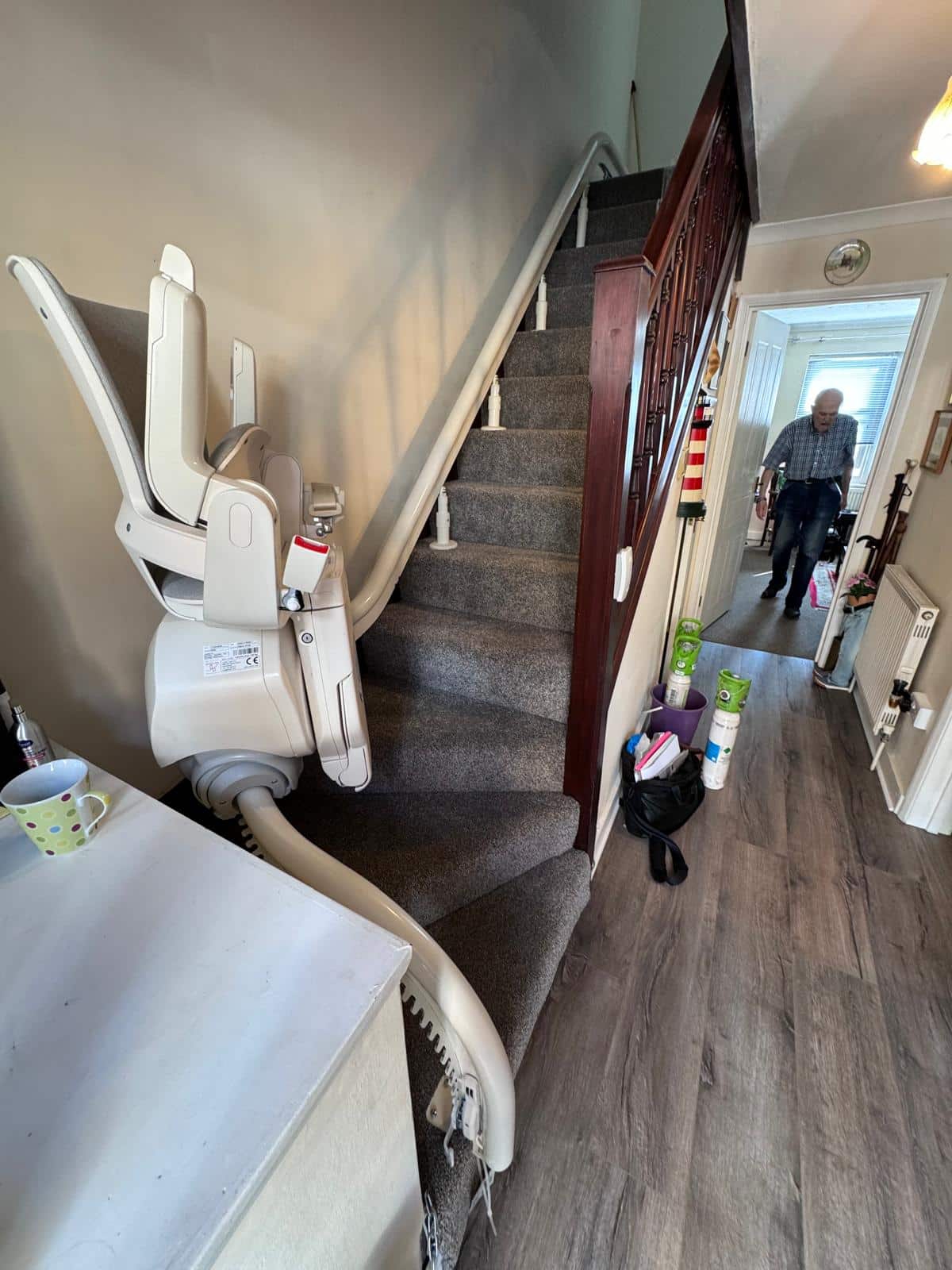 Stairlift shown in one of its parking positions up the curved staircase