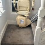 Brooks stairlift in its folded up position at the bottom of the stairs