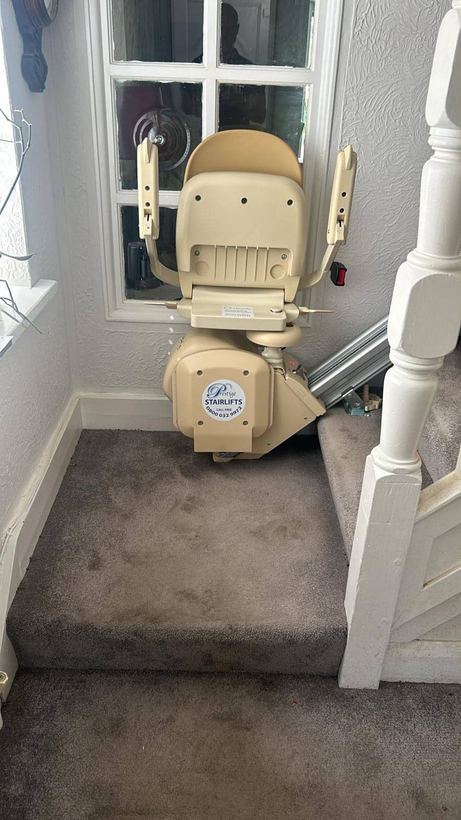 Brooks stairlift in its folded up position at the bottom of the stairs