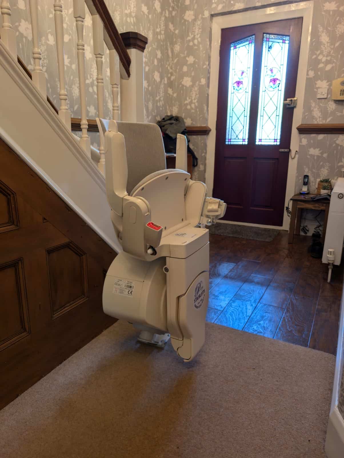 Otolift stairlift in its parked and folded position at the bottom of the stairs