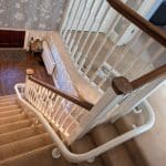 Curved rail shown from the top of the stairs all the way to the bottom of the stairs