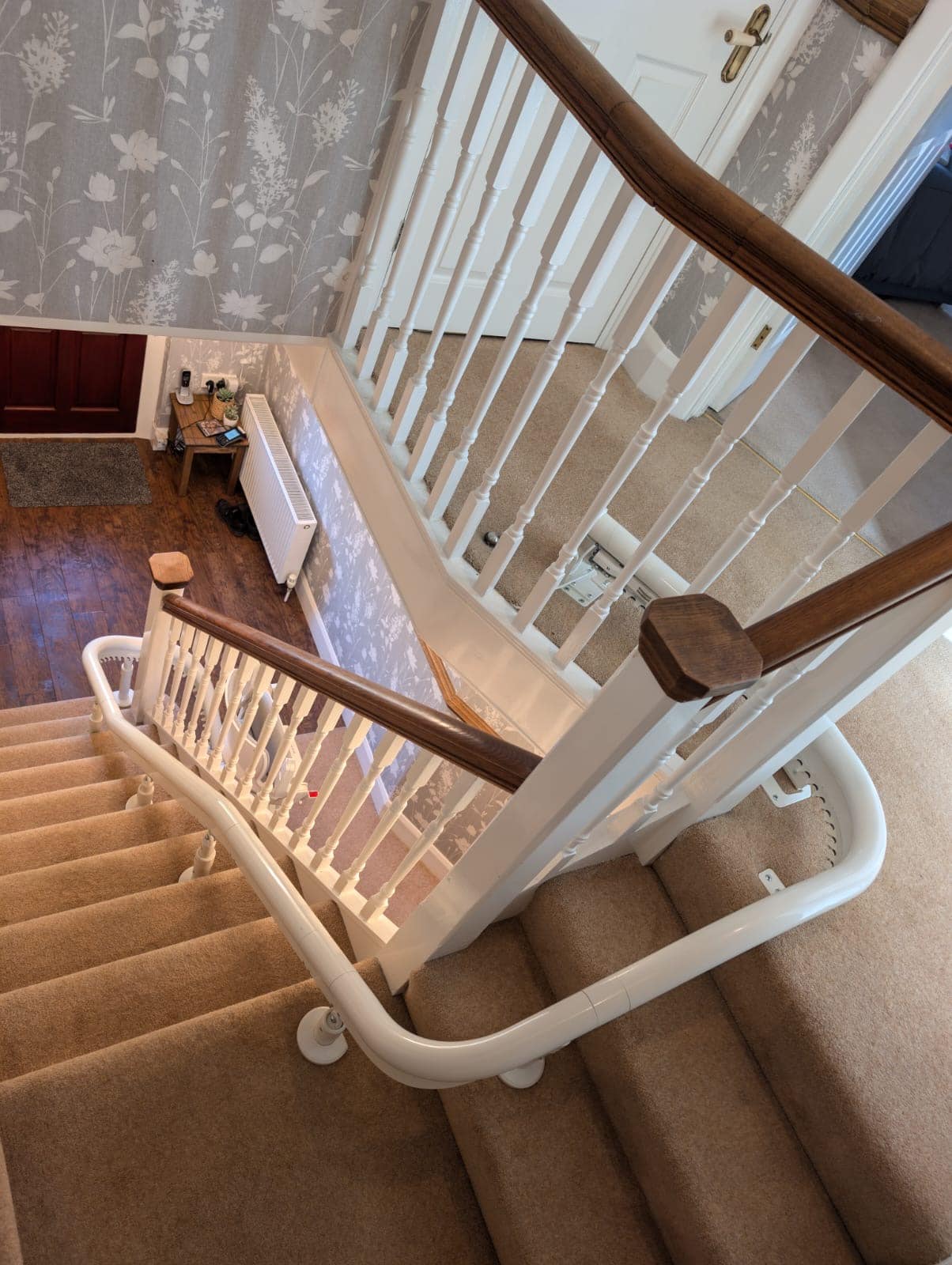 Curved rail shown from the top of the stairs all the way to the bottom of the stairs