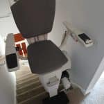 Flow X stairlift in its getting off position at the top the stairs