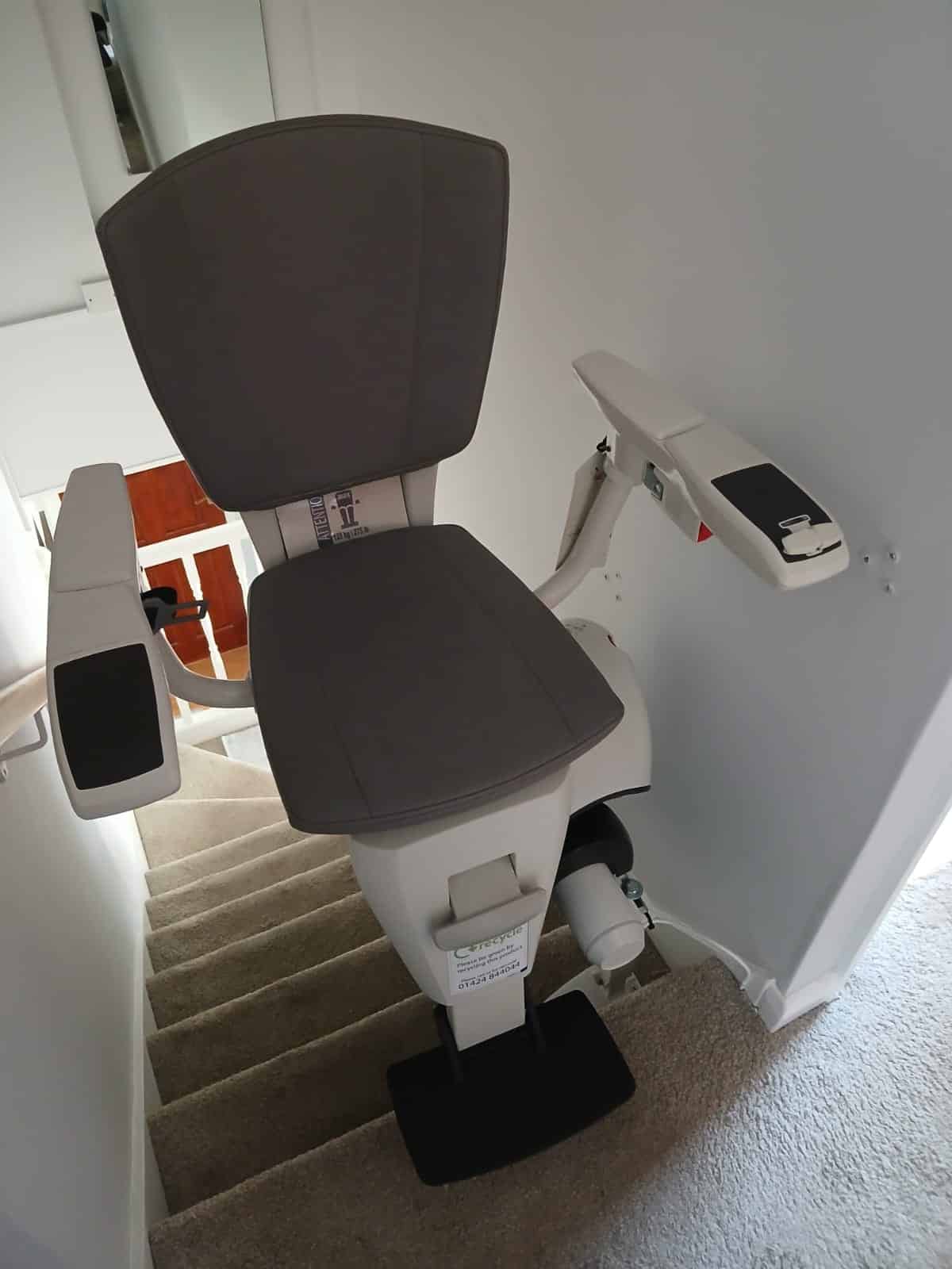Flow X stairlift in its getting off position at the top the stairs